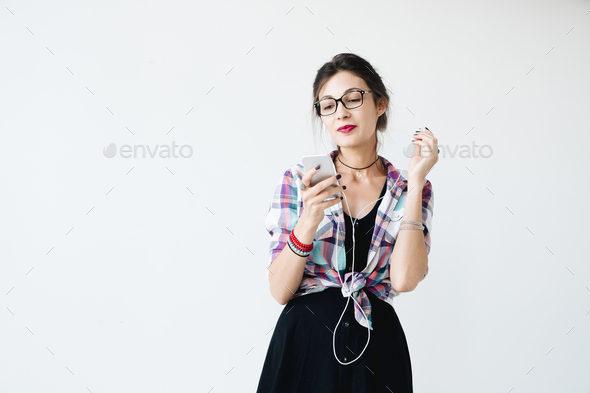 Girl putting on her earphones - Stock Photo - Images