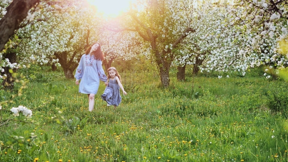 Mum with Daughter Walk Together on Nature alt