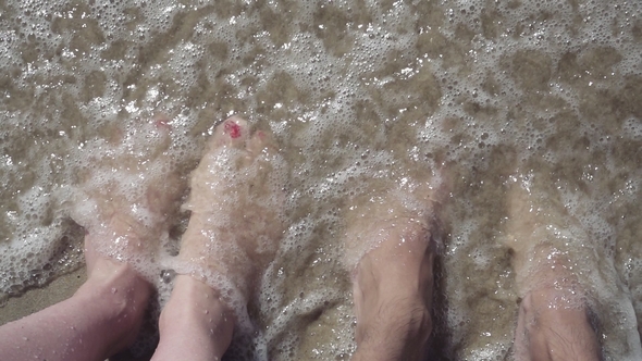 Girl and Man Legs in the Ocean.  Video