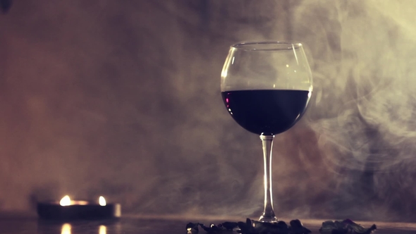 Red Wine in Glass in Smoke Background