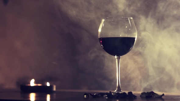 Red Wine in Glass in Smoke Background