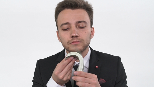 Businessman Turning Over Money Near the Face