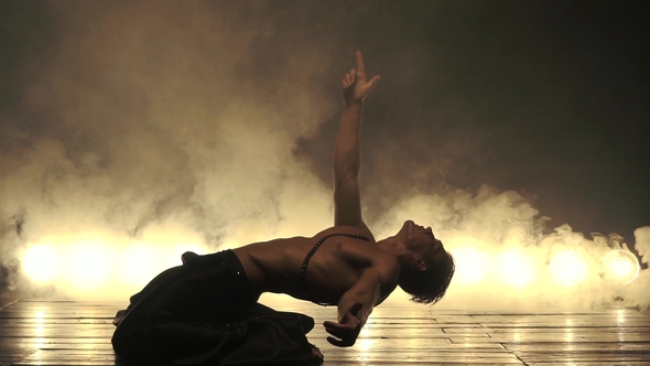 Sexy Man Dance in Light and Smoky Background
