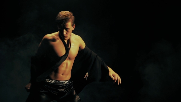 Sexy Man Dance on Black Background