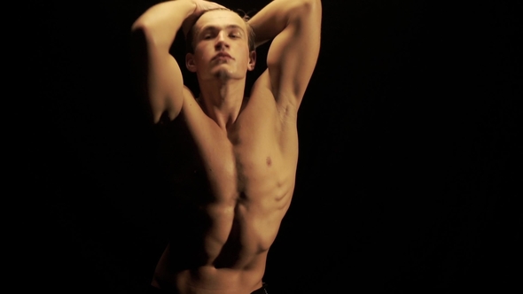 Sexy Man Dance on Black Background