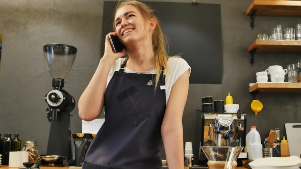 Young Female Calling Using Cell Phone at Work Place alt