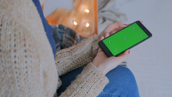 Woman Looking at Smartphone with Green Screen