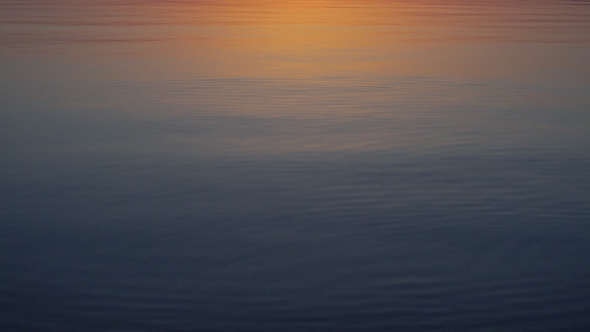 Stone Skipping on Calm Water, Beautiful Sunset Around
