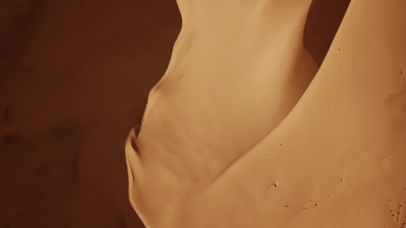 Aerial View on Sand Dunes in Desert at Sunrise alt