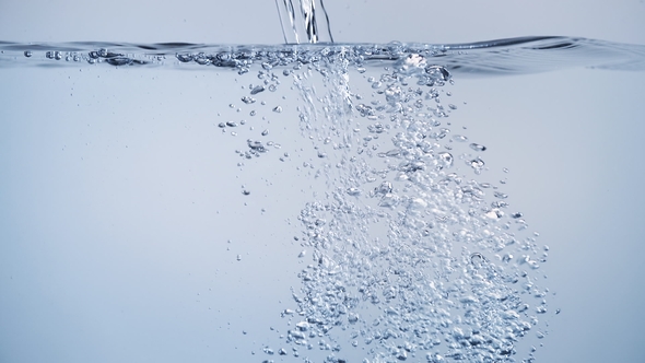 Clean Water Flowing With Bubbles Of Air And Splashes On White 