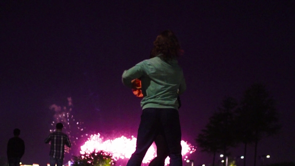 Couple Dancing Against Fireworks in Night City