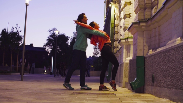 Couple Dancing in the City Near the Building