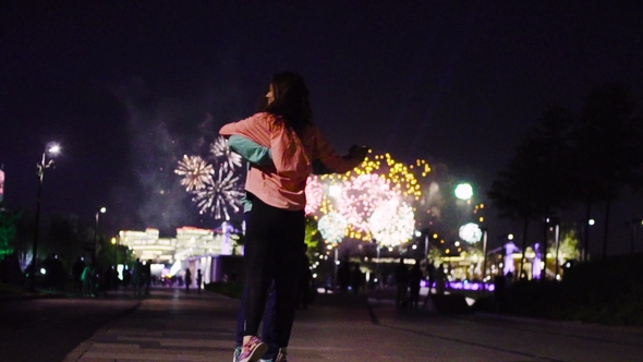Couple Dancing Against Fireworks in Night City