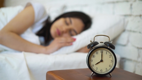 Tired Brunette Turning Off Her Alarm Clock in Her Bedroom, Stock Footage