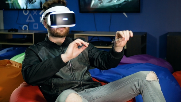 Player Sees Virtual Reality for the First Time. A Young Man Tries To Grab Hold of Non-existent