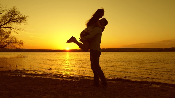 Happy Couple Dancing at Sunset on Beach. Romantic Evening of Couple in Love on the Beach