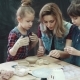 Mother and Two Daughters in a Creative Class in the Pottery Workshop. Children Make Shapes Out of