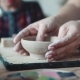 Girl Makes Craft Clay Plate. Women's Hands. Handmade Clay Dish