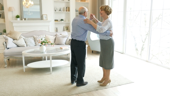 Old Retired People and Leisure Activities, Happy Senior Couple Dancing Valse for Fun at Living Room
