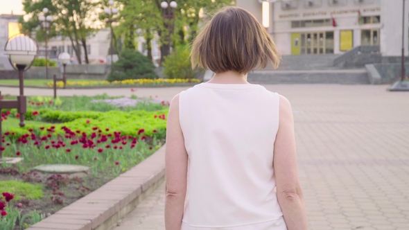 Beautiful Woman Walking in Park