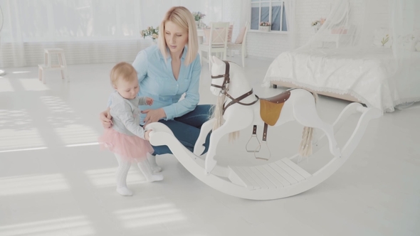 Mother and Daughter Playing Near Swing Happy Blonde Woman and Baby Sitting Near Swing