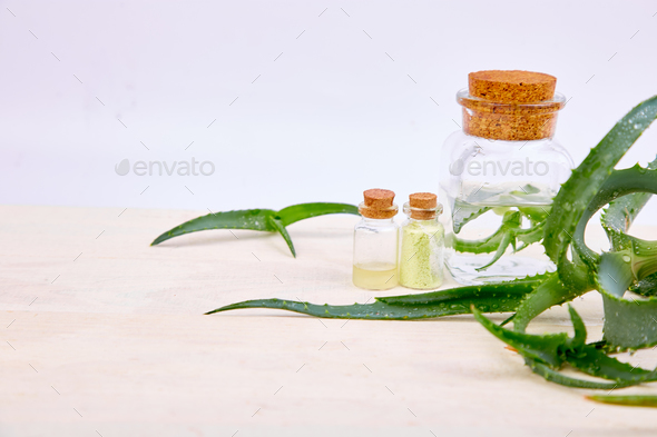 Aloe vera oil in glass bottle and towel for spa - Stock Photo - Images