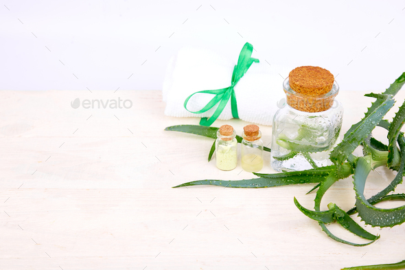 Aloe vera oil in glass bottle and towel for spa - Stock Photo - Images