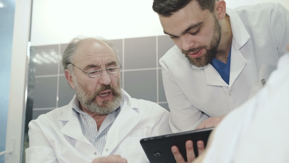 Two Medical Doctor Giving Good News To Couple in the Hospital alt