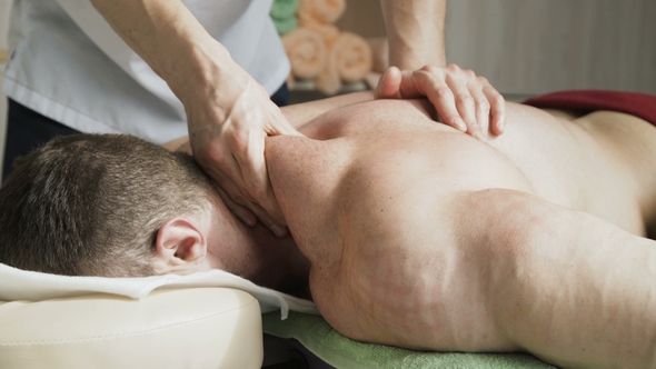 Sports Manual Massage for Handsome Athlete in Beauty Studio. alt