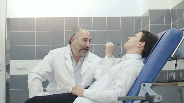 Experienced Doctor Consulting and Favoring the Patient in Hospital. alt