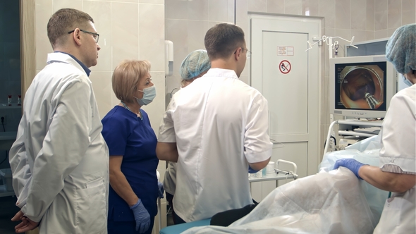 Doctors Looking at Endoscope Monitor During Surgical Operation, Stock ...