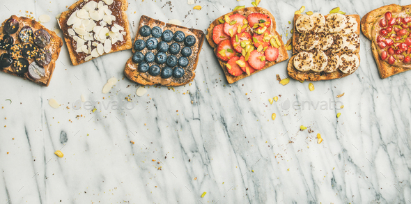 Vegan whole grain toasts with fruit, seeds, nuts, copy space - Stock Photo - Images