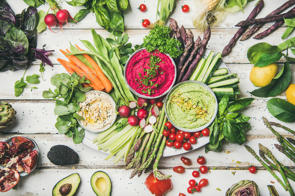 Chickpea, beetroot, spinach hummus dips with colorful vegetables and greens - Stock Photo - Images