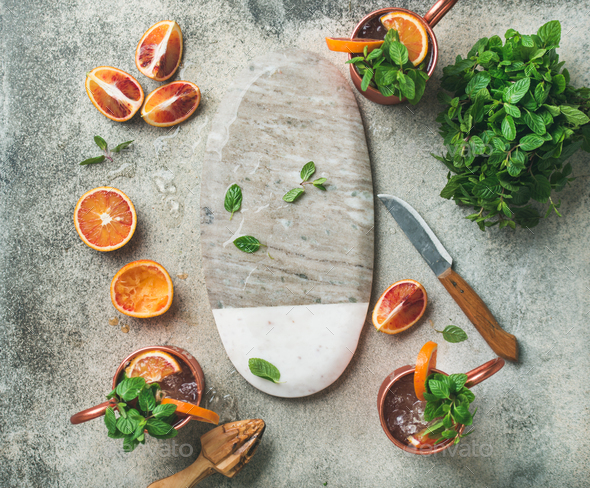 Blood orange Moscow mule alcohol cocktails and board in center - Stock Photo - Images