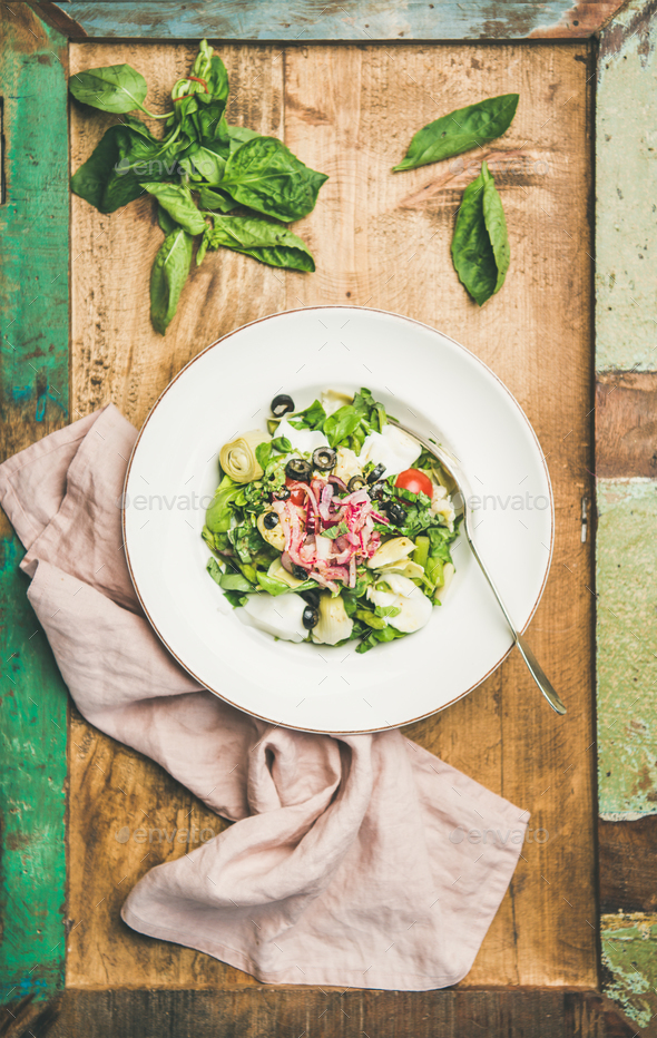 Fresh green summer salad with artichokes over rustic background - Stock Photo - Images