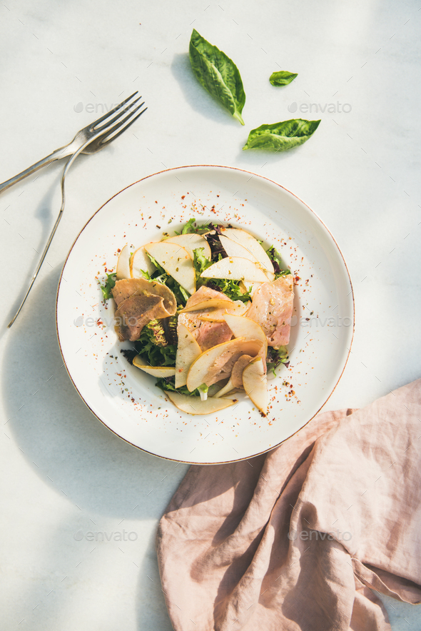 Summer salad with smoked turkey ham and pear, white background - Stock Photo - Images