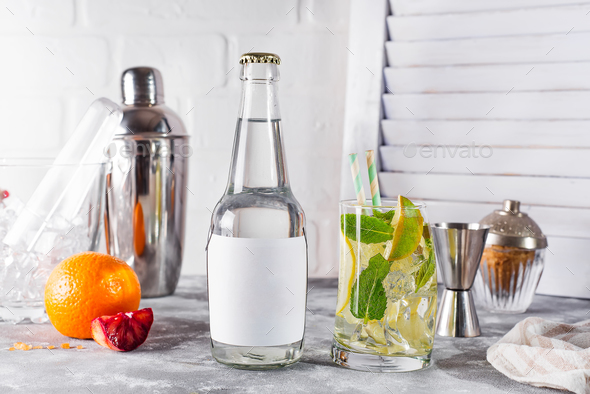 Mojito classic cocktail with lime and mint in a glass on white wooden background , - Stock Photo - Images