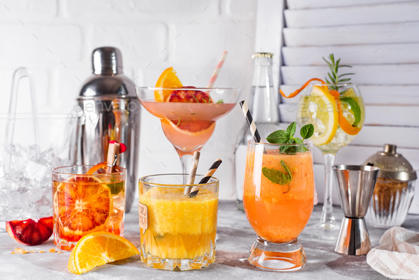 Set of classic cocktails of gin tonic with orange, with lime and mint leaves in glasses - Stock Photo - Images