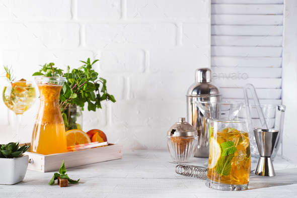 lemonade in the decanter on a wooden tray and Cocktail shaker for preparing a summer cocktail - Stock Photo - Images