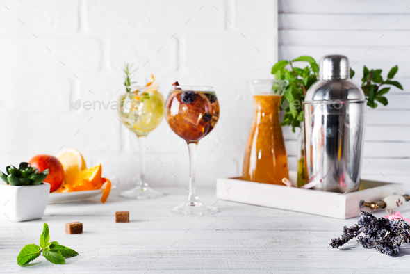 lemonade in the decanter on a wooden tray and Cocktail shaker for preparing a summer cocktail - Stock Photo - Images