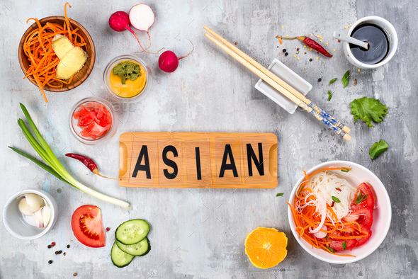Asian rice noodles with vegetables and vegetarian salad on a plate on stone background - Stock Photo - Images