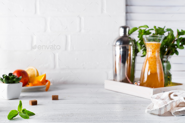 lemonade in the decanter on a wooden tray and Cocktail shaker for preparing a summer cocktail - Stock Photo - Images