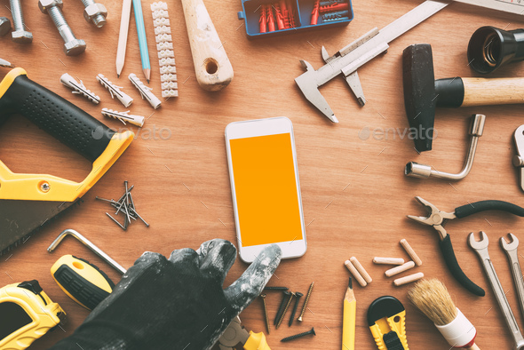 Handyperson smart phone app, repairman holding mobile phone in h - Stock Photo - Images