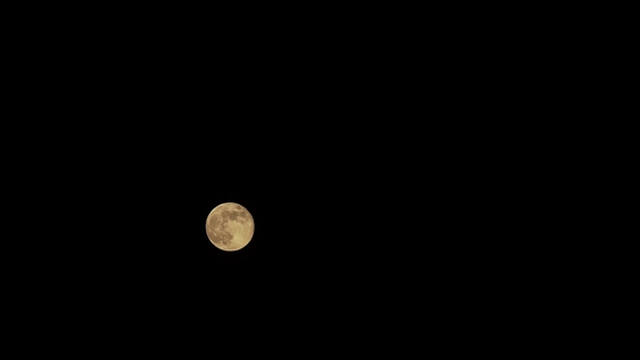 Full Moon Behind Clouds at Night. Moonshine