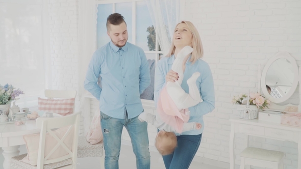 Happy Family Playing with Their Lovely Child.