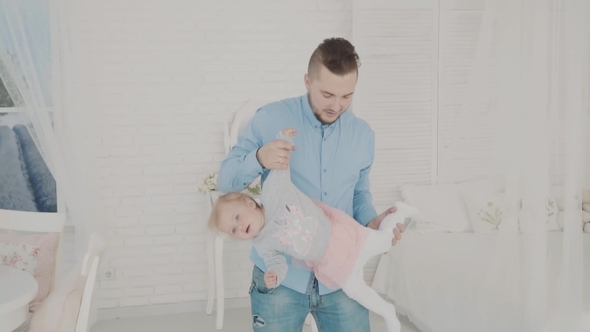 Father Swinging His Beautiful Daughter in the Room.