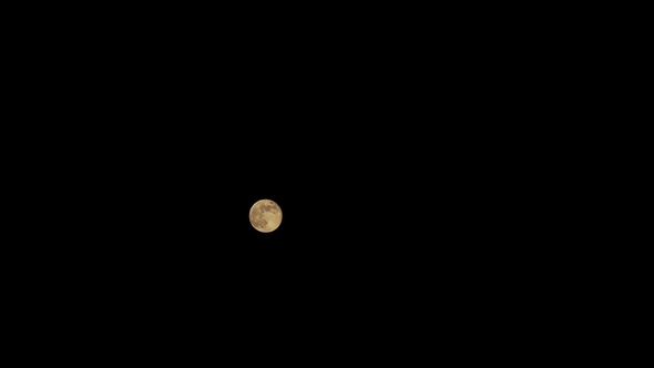 Full Moon Behind Clouds at Night