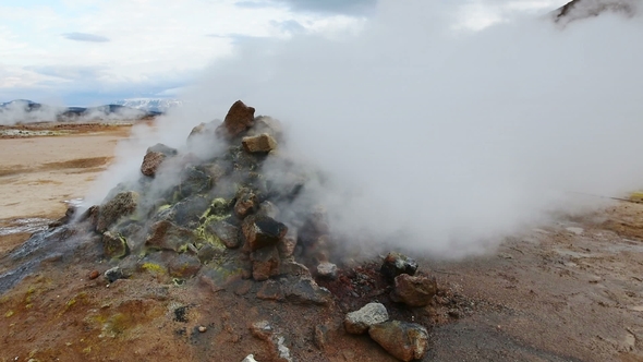 Eruption of Geyser in Iceland. Red Soil, Like the Surface of the Planet Mars alt