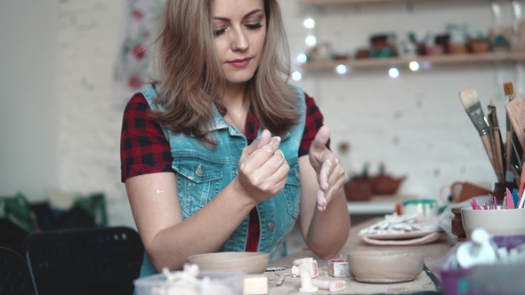 Attractive Young Caucasian Woman Spends Time Behind a Creative Hobby. the Girl Enthusiastically