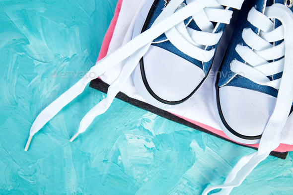 Flat lay of female sneakers shoes and tee - Stock Photo - Images